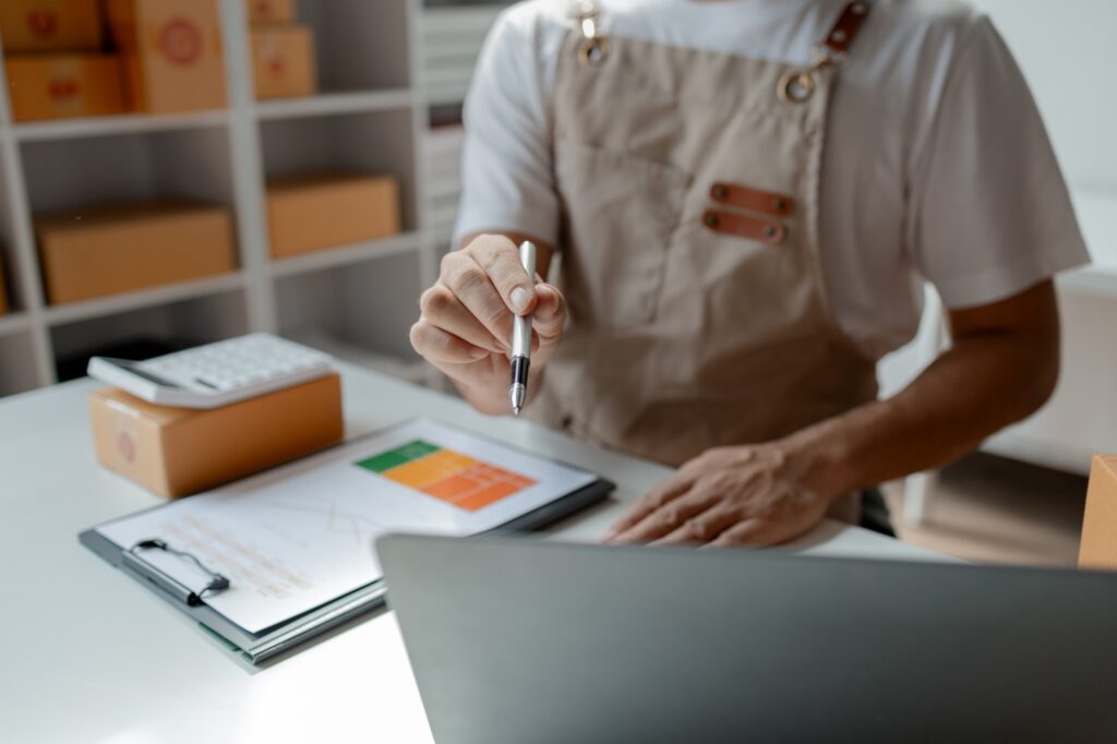owner of an online store looks at web to print solutions on a laptop